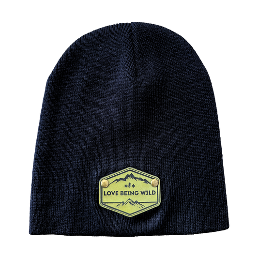 Black beanie with a green 'Love Being Wild' patch on a white background