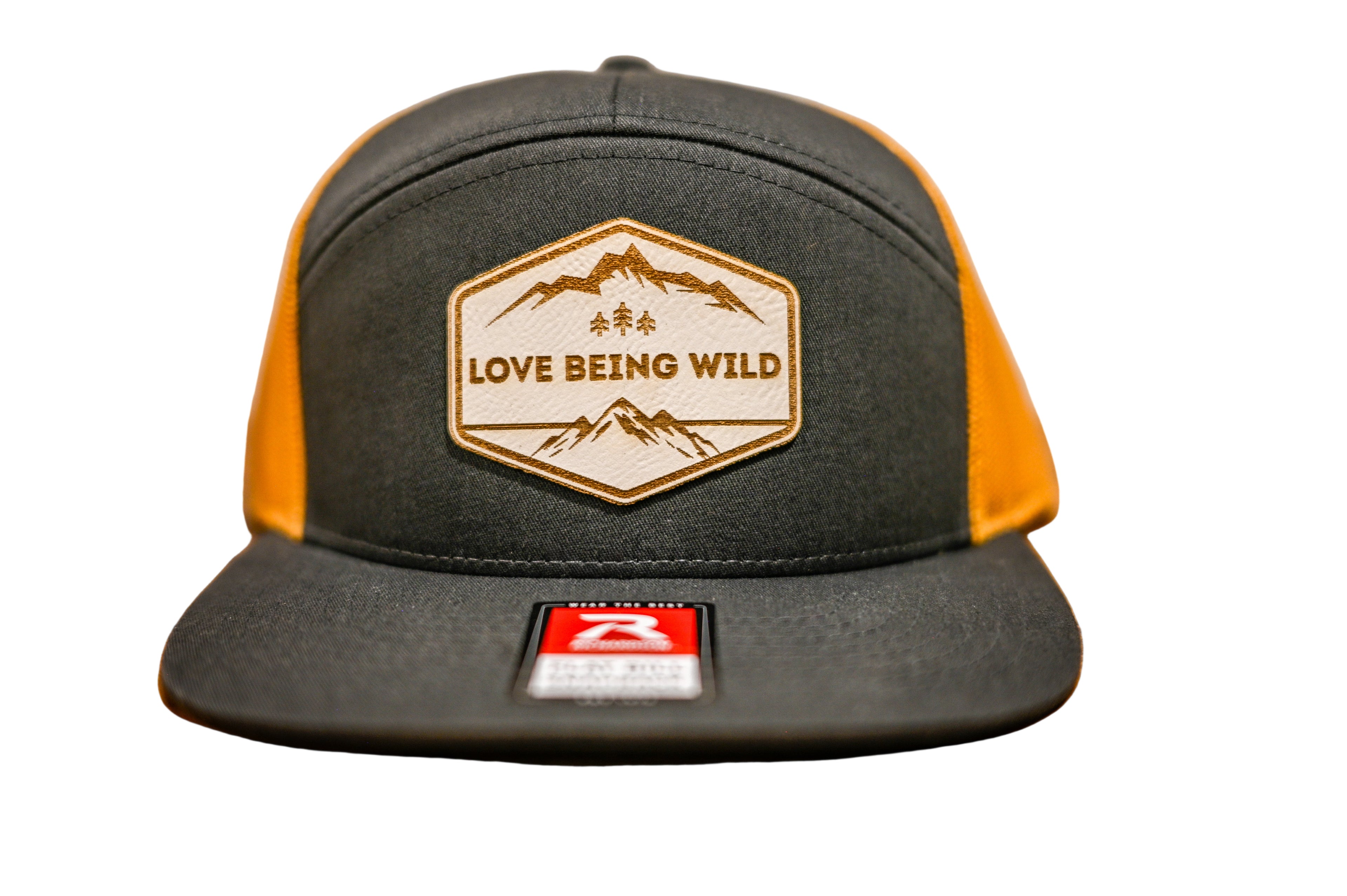 Black and yellow cap with 'Love Being Wild' logo on a leatherette patch