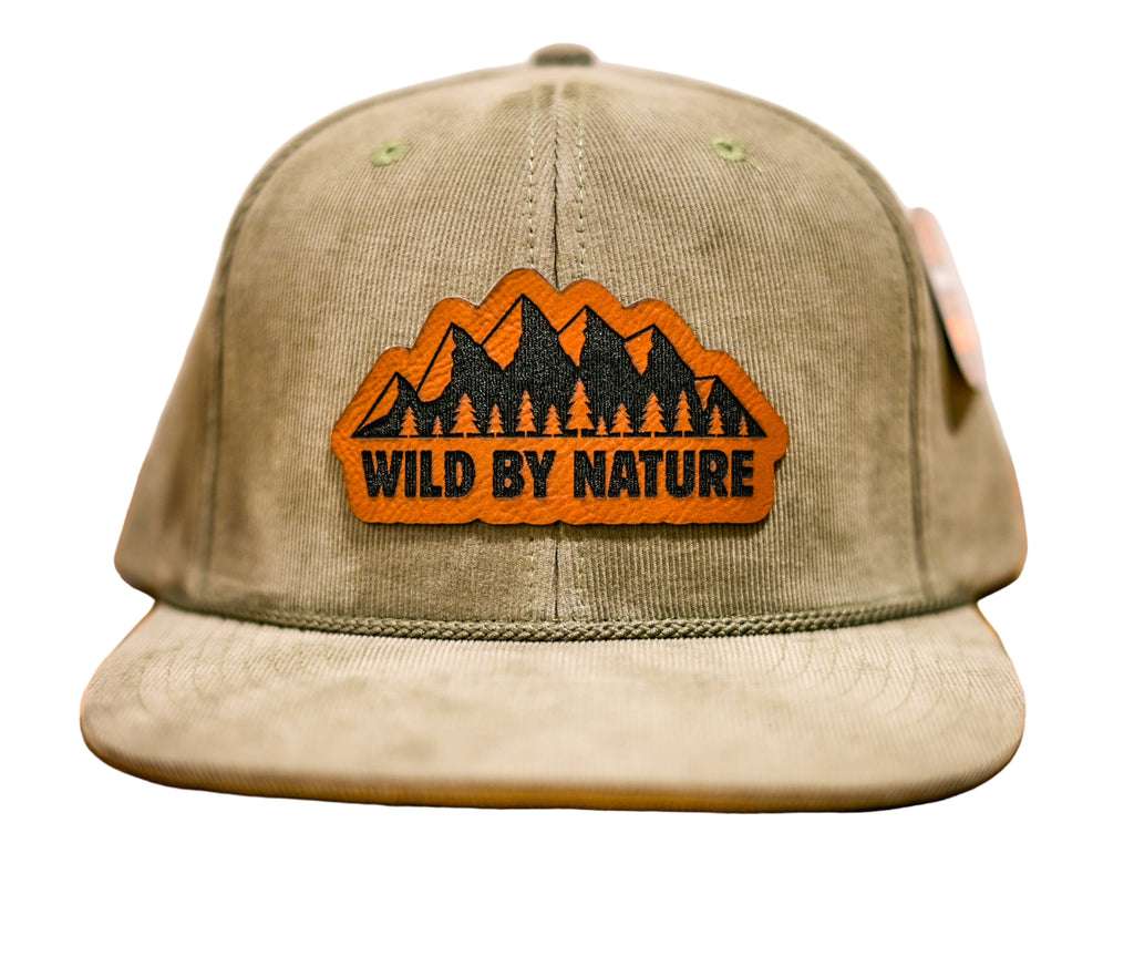 Green cap with 'Wild by Nature' logo on a leatherette surface
