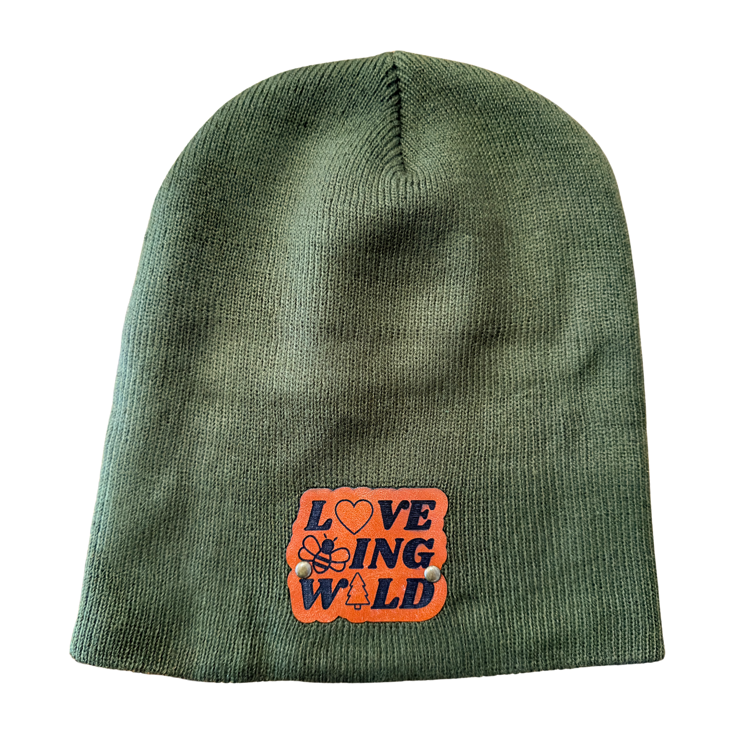 Green beanie with an orange patch featuring text and symbols on a white background