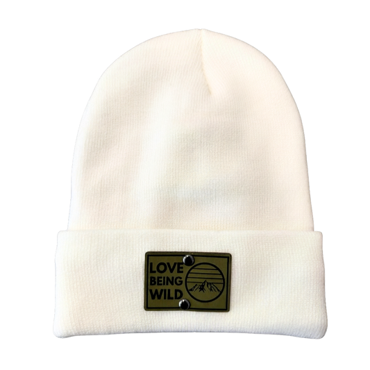 White beanie with a patch that says 'Love Being Wild' on a white background