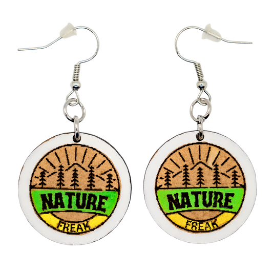 Nature Freak badge earrings with pines and mountains
