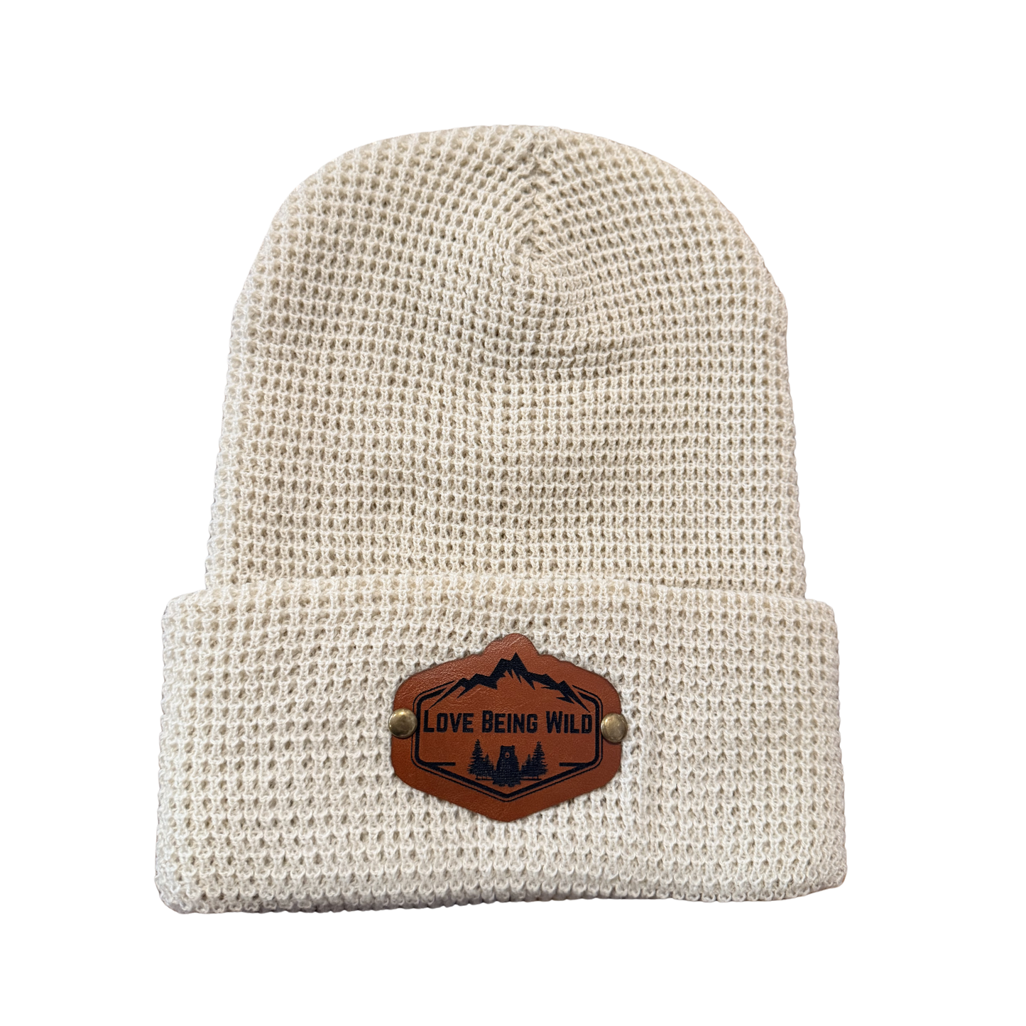 Beige knit beanie with a leather patch on a white background