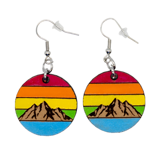 Colorful round earrings with mountain design on a white background