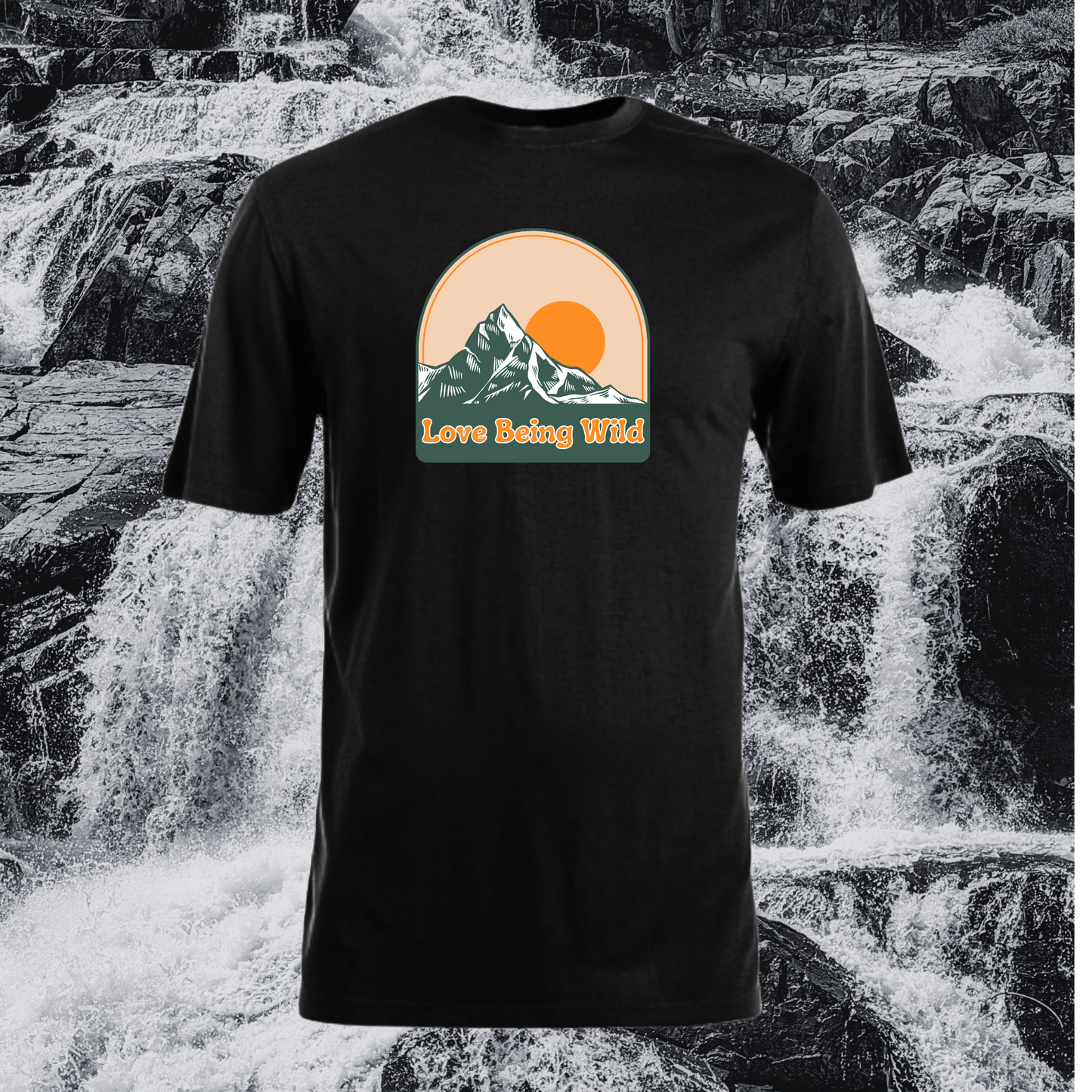 Black t-shirt with mountain graphic and 'Love Being Wild' text in front of a waterfall.
