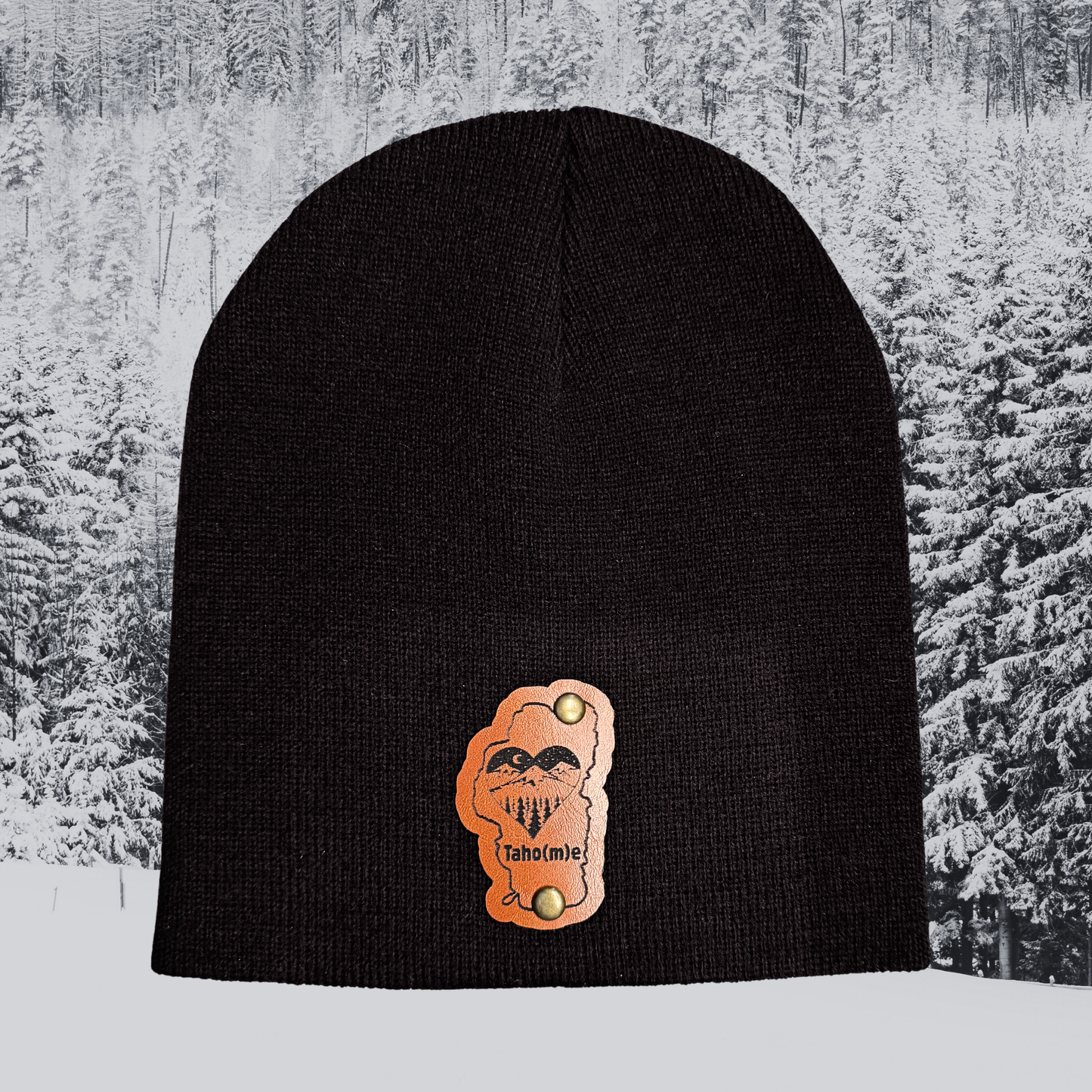 Black beanie with a skull design on a snowy background