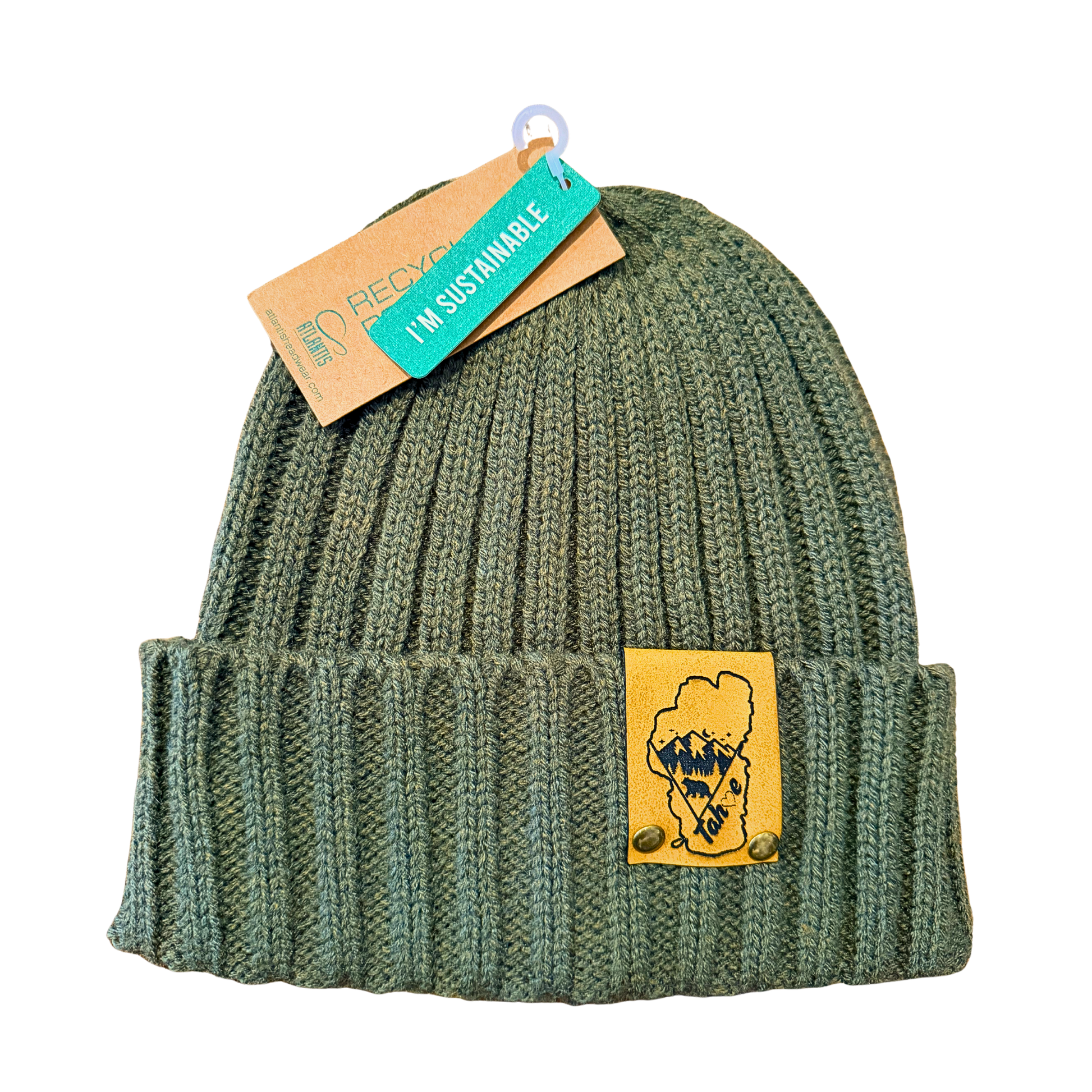 Green knit beanie with a patch and a sustainability tag on a white background