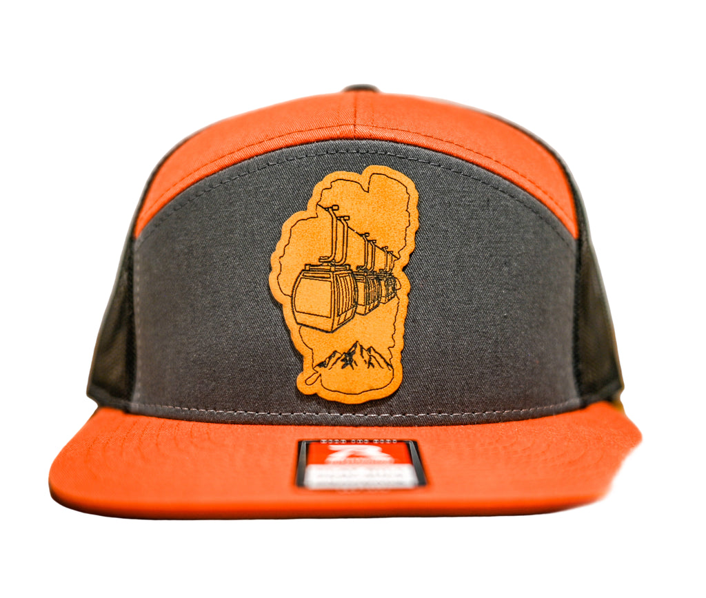 Gray and orange cap with a logo on a leatherette patch