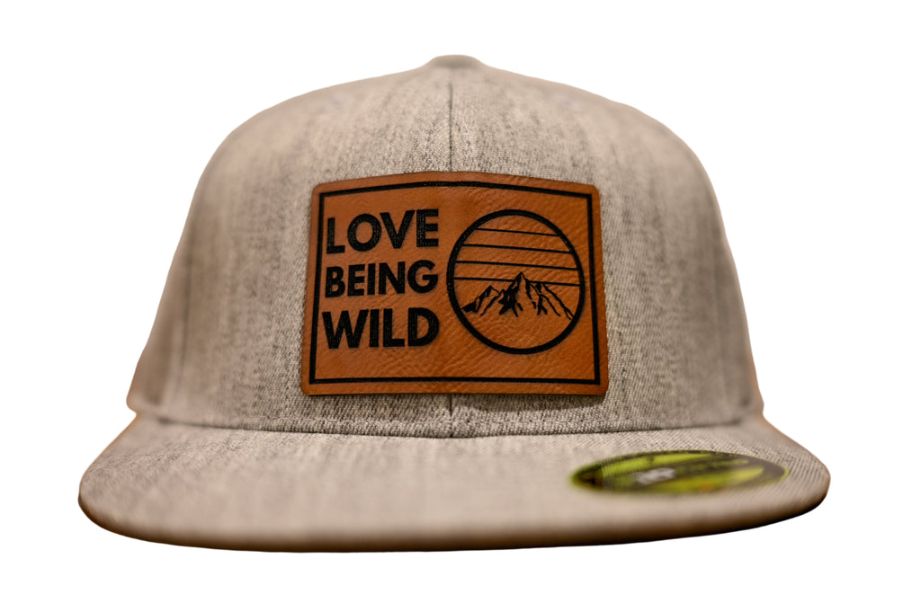 Gray cap with a brown leather patch featuring 'Love Being Wild' 